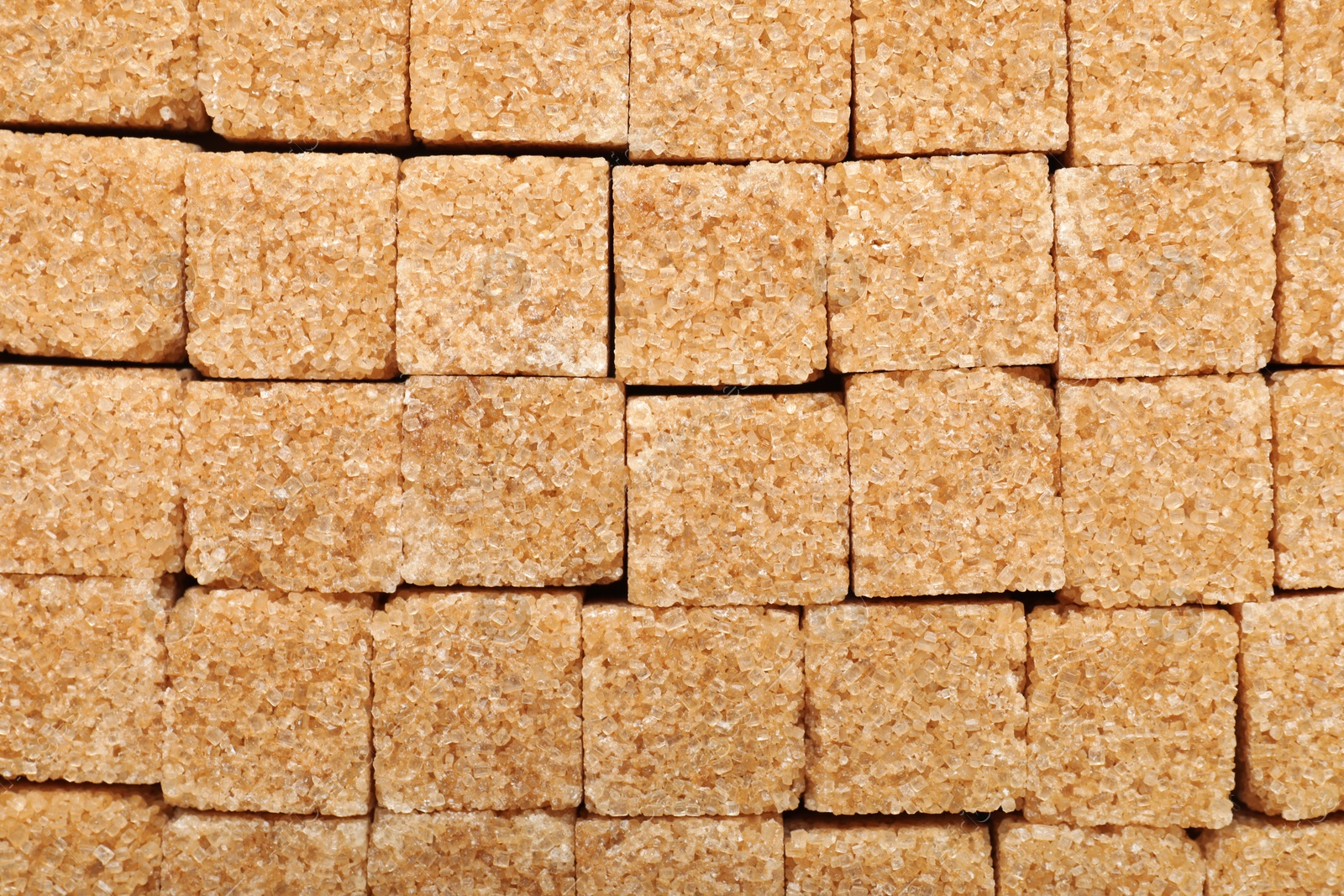 Photo of Brown sugar cubes as background, top view