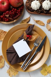 Photo of Happy Thanksgiving day. Beautiful table setting with autumn decor and empty card, flat lay