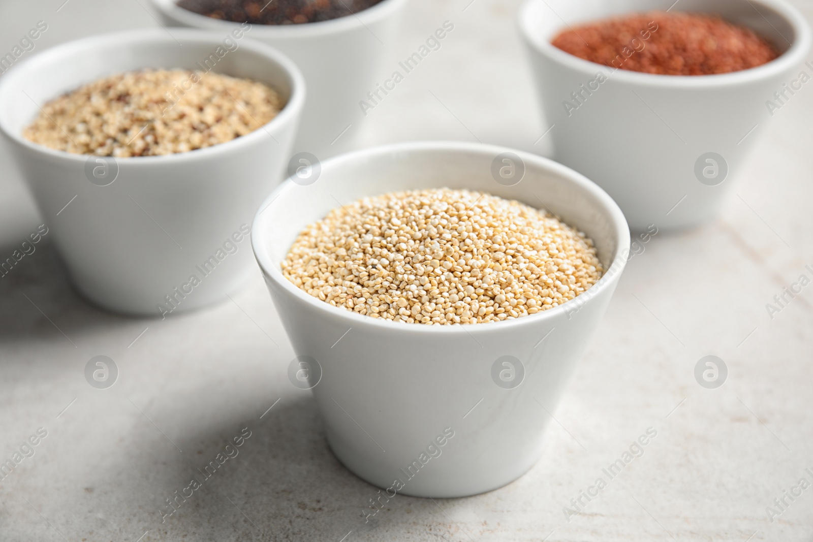 Photo of Bowl with white quinoa seeds on table