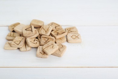 Pile of runes on white wooden table