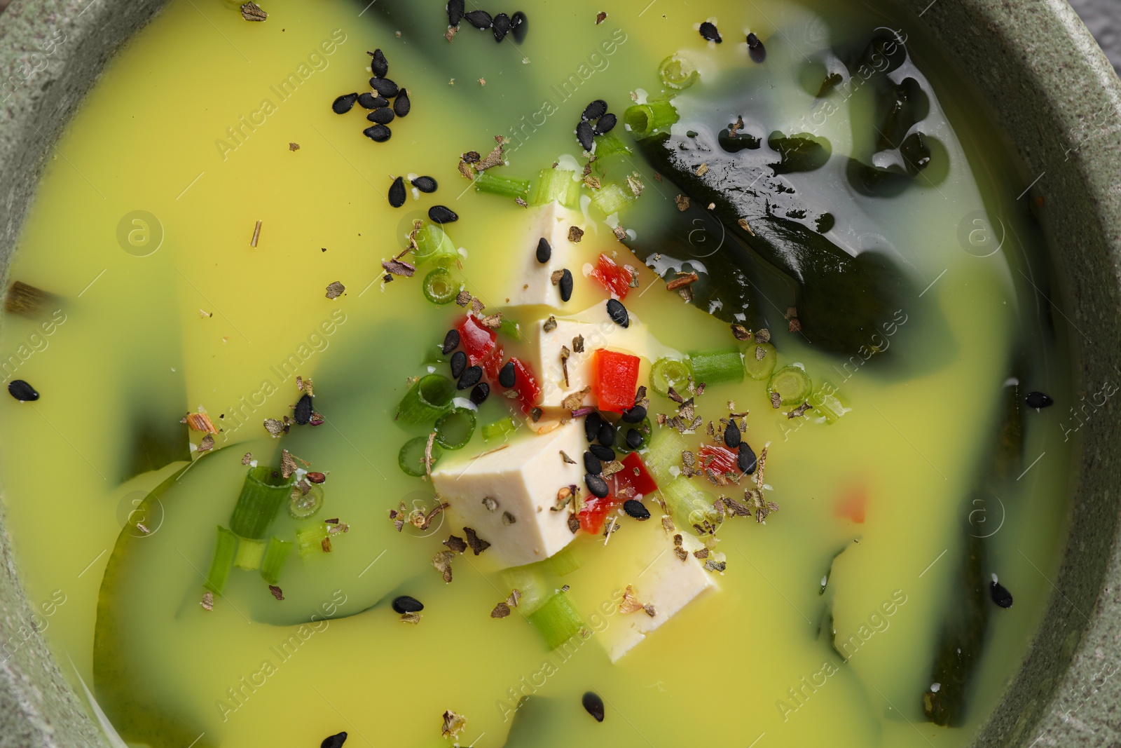 Photo of Bowl of delicious miso soup with tofu, top view