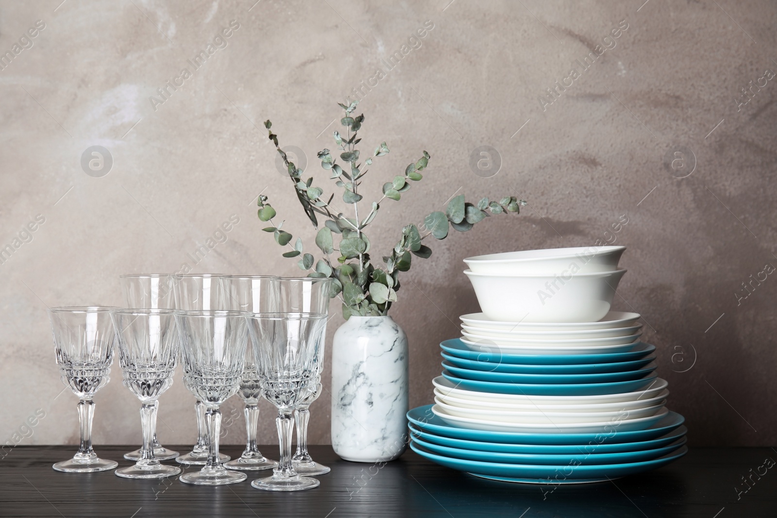 Photo of Composition with dinnerware on table against grey background. Interior element