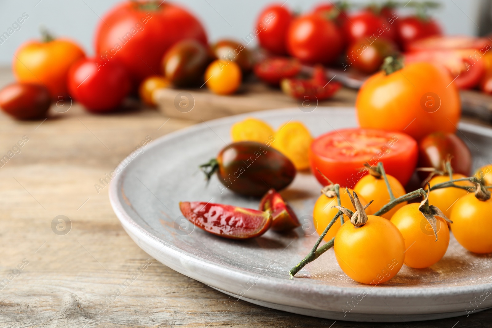 Photo of Fresh ripe tomatoes on wooden table, closeup