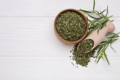 Photo of Bowl of dry tarragon, scoop and fresh leaves on white wooden table, flat lay. Space for text