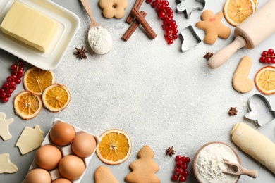 Photo of Flat lay composition with homemade Christmas cookies and ingredients on grey table, space for text