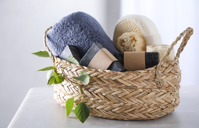 Photo of Natural tar soap in wicker basket on white table