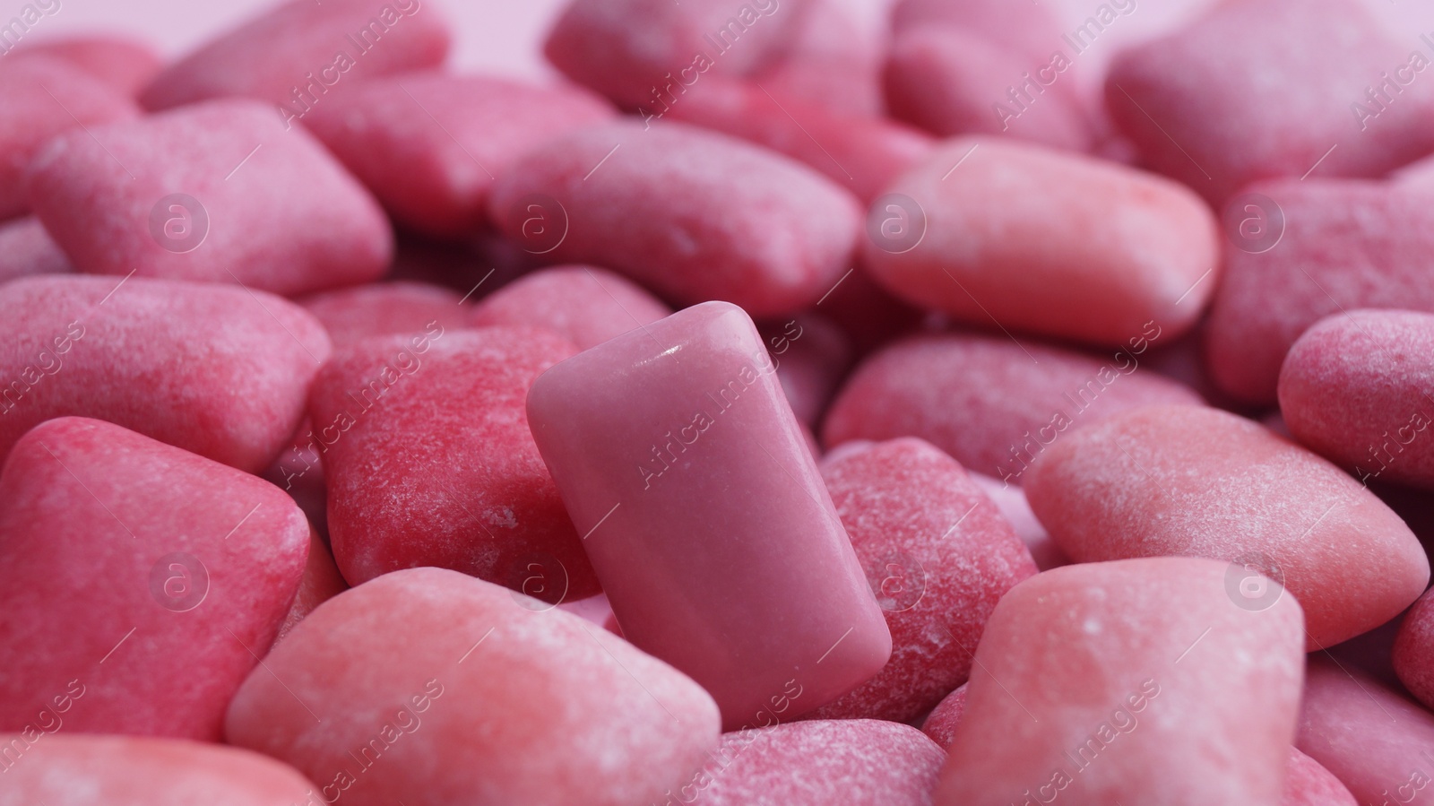 Photo of Many pink chewing gums as background, closeup