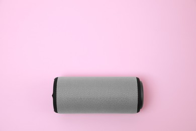 Photo of One portable bluetooth speaker on pink background, top view with space for text. Audio equipment