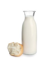 Photo of Bottle of milk and bun on white background