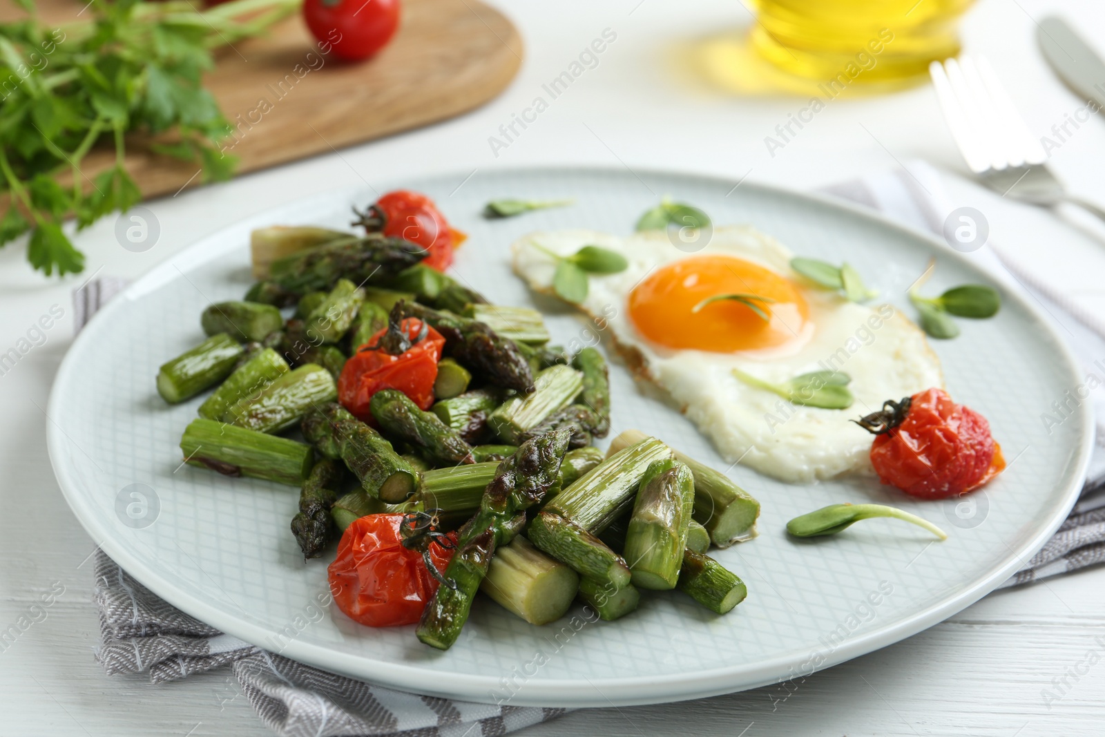 Photo of Oven baked asparagus served with fried egg on plate