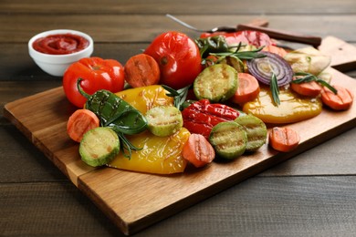 Delicious grilled vegetables with rosemary on wooden table