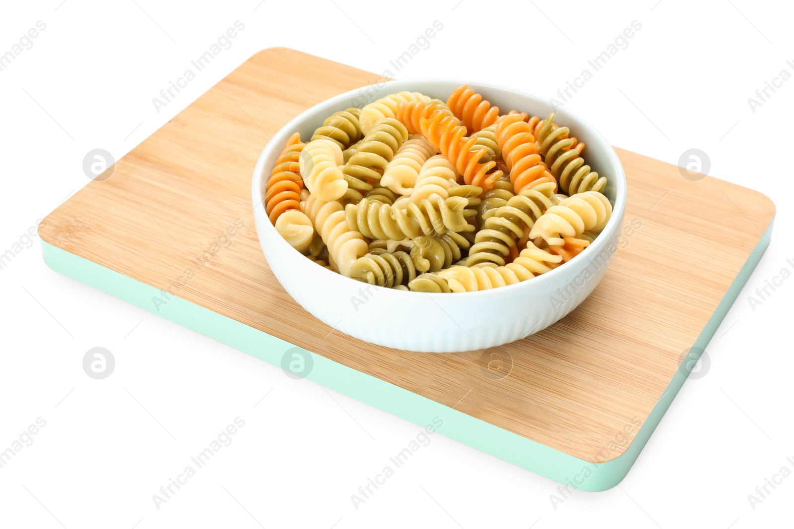 Photo of Wooden board with bowl of tasty fusilli pasta on white background