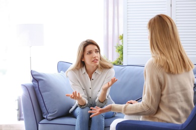 Female psychologist with client in office