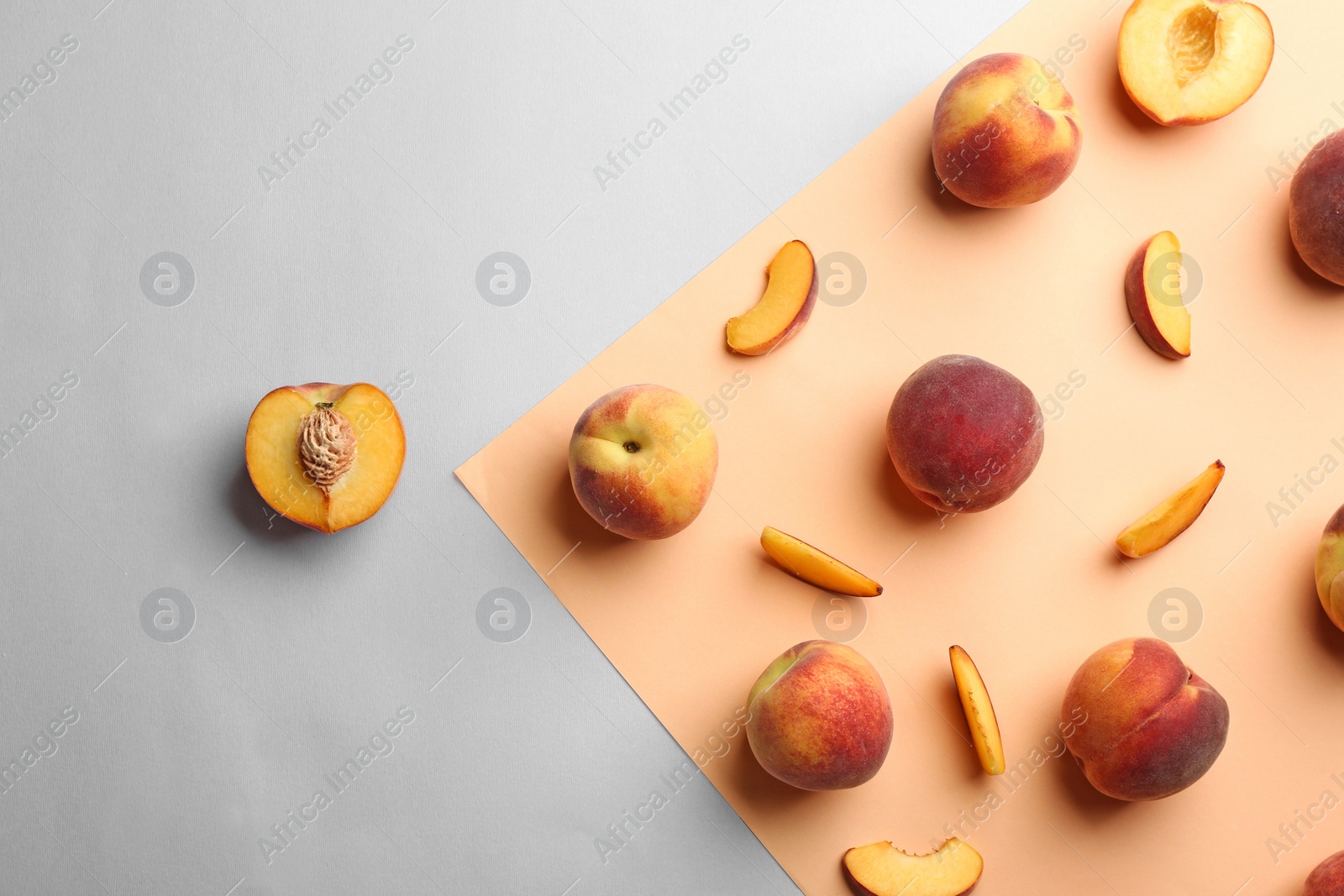 Photo of Flat lay composition with fresh peaches on color background