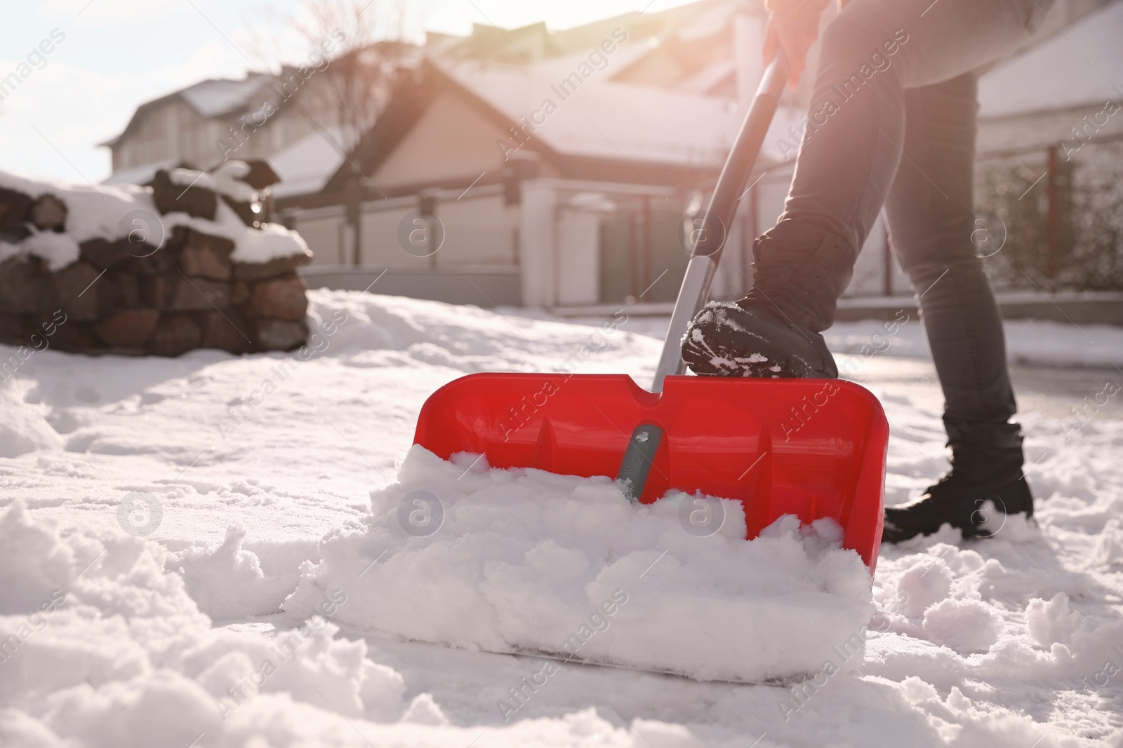 Photo of Person shoveling snow outdoors on winter day, closeup