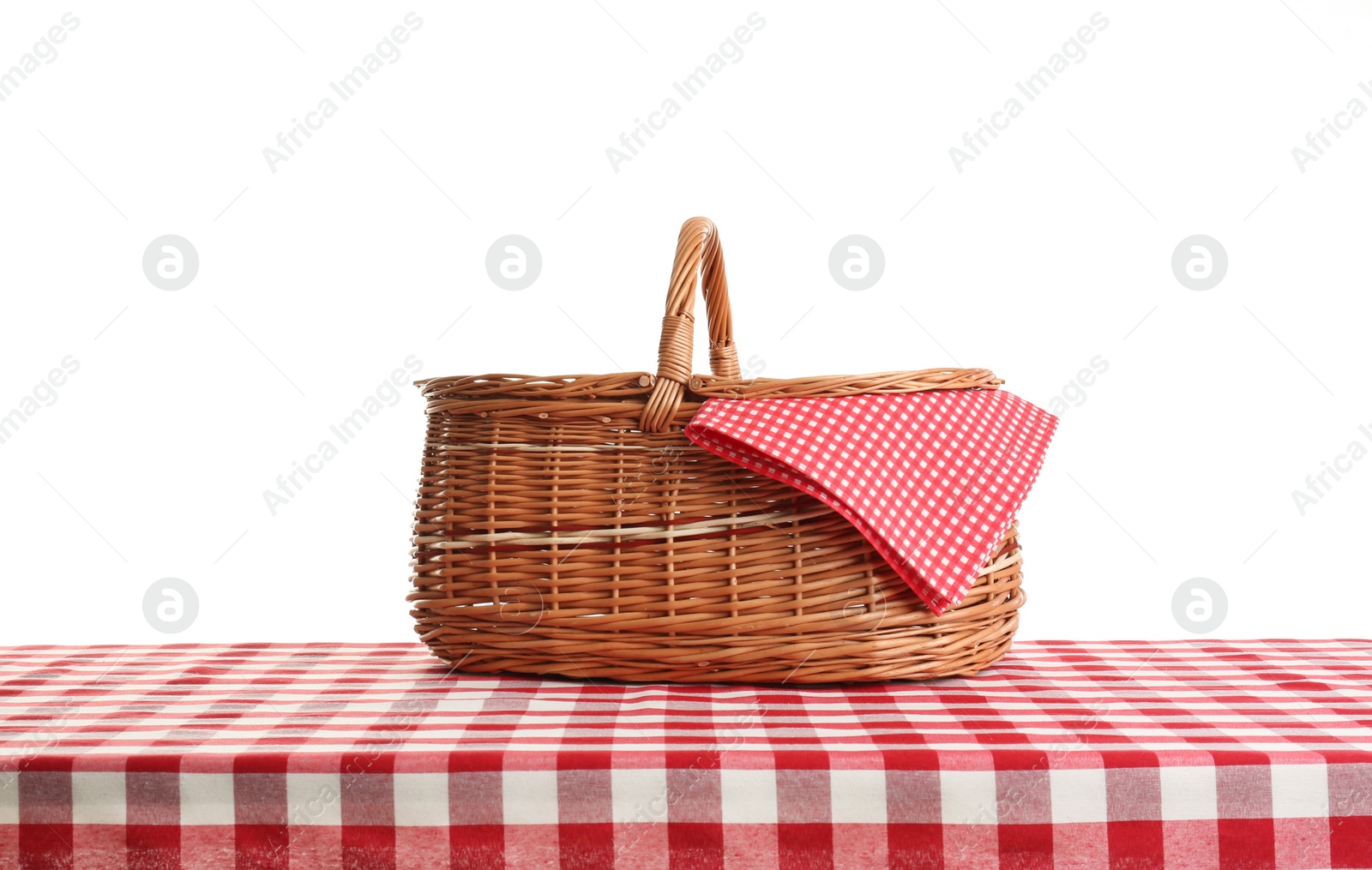 Photo of Empty picnic basket on checkered tablecloth against white background