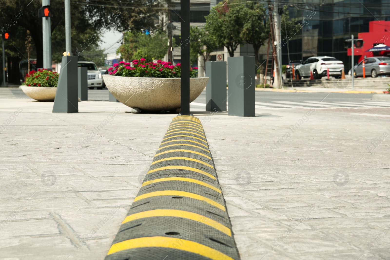 Photo of City street with striped plastic speed bump