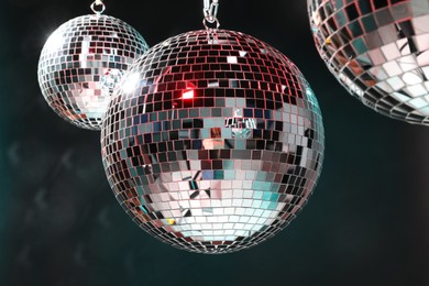 Photo of Bright shiny disco balls on dark background