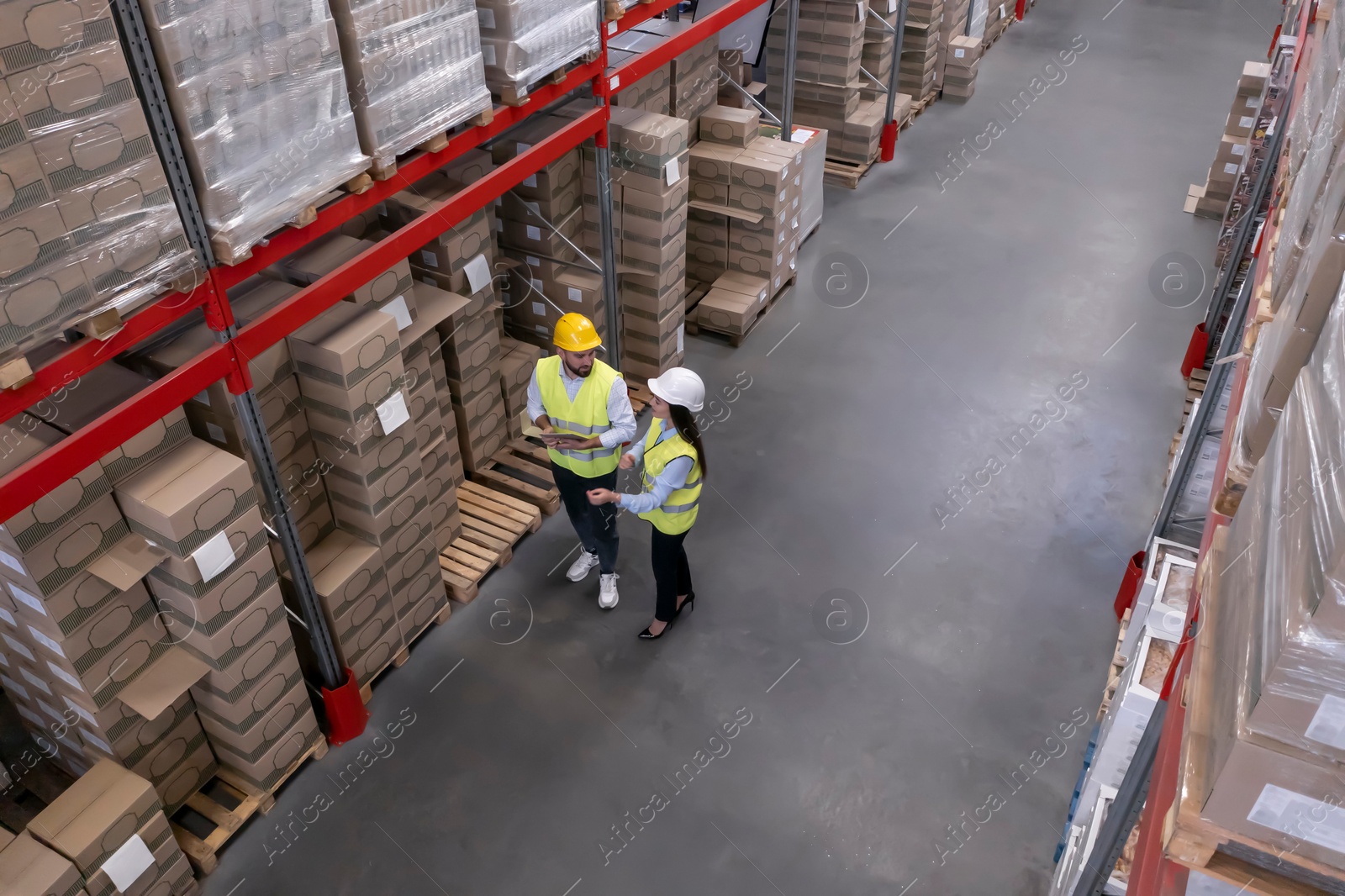 Image of Manager and worker at warehouse, above view. Logistics center