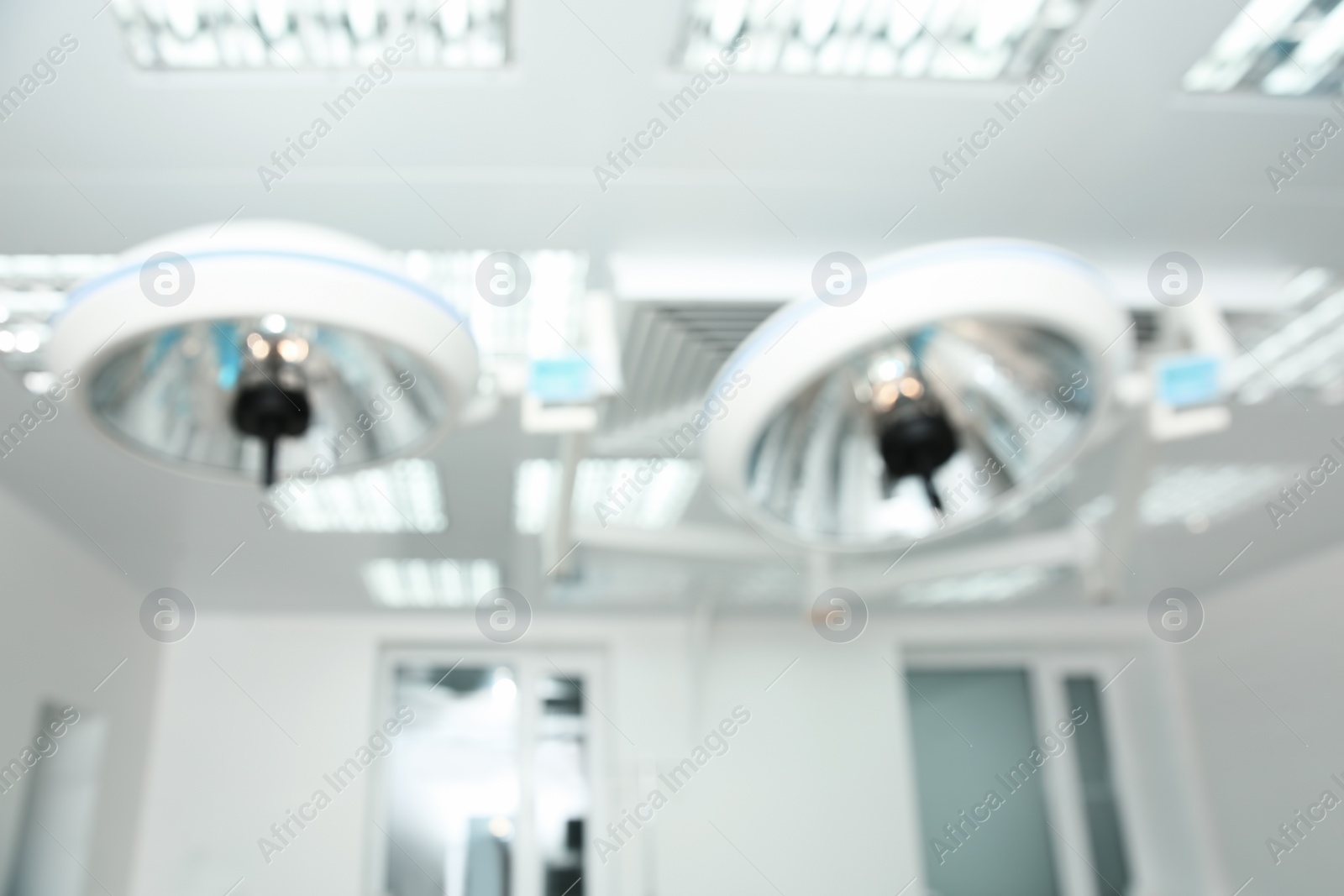 Photo of Blurred view of powerful surgical lamps in modern operating room