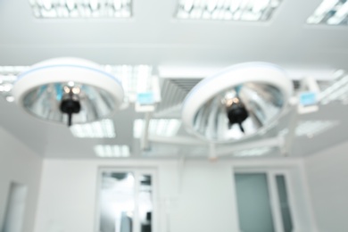 Blurred view of powerful surgical lamps in modern operating room