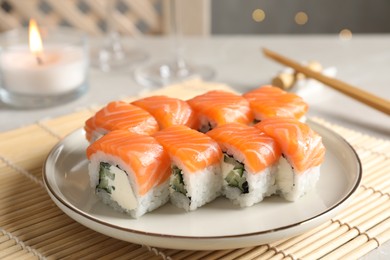 Tasty sushi rolls served on table, closeup