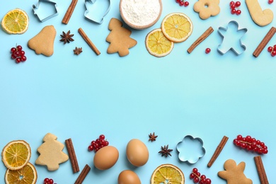 Photo of Frame of Christmas cookies and flour on light blue background, flat lay. Space for text