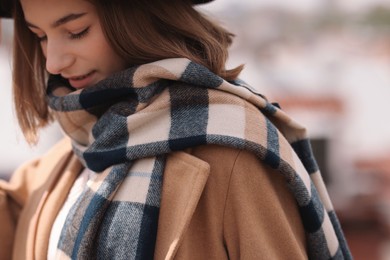 Beautiful woman in warm scarf on city street