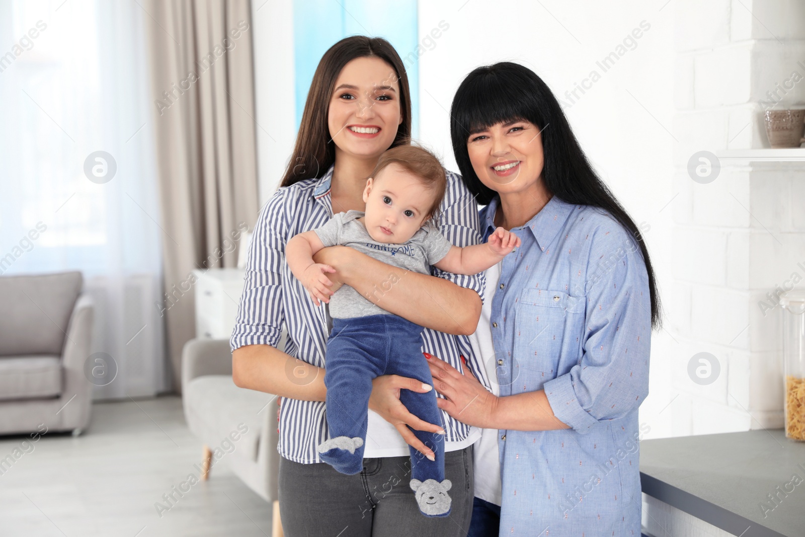 Photo of Portrait of young woman, her baby and mature mother indoors