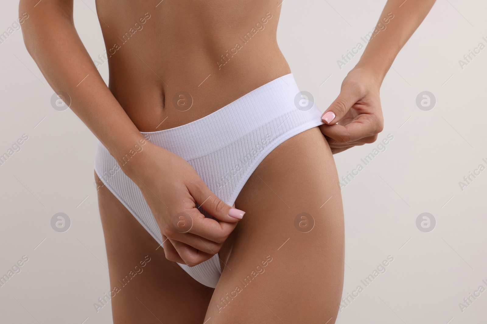 Photo of Young woman in stylish bikini on white background, closeup