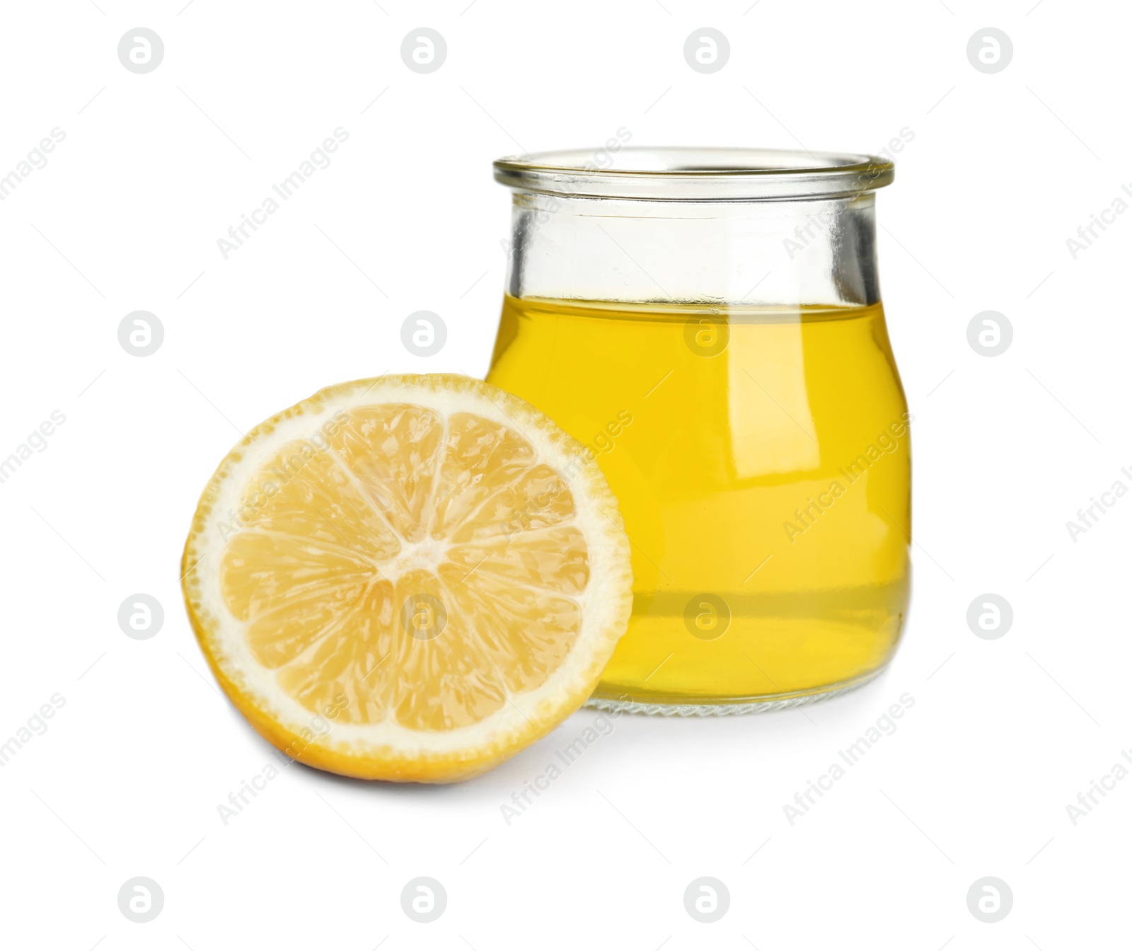 Photo of Piece of lemon and tasty jelly dessert in glass jar on white background