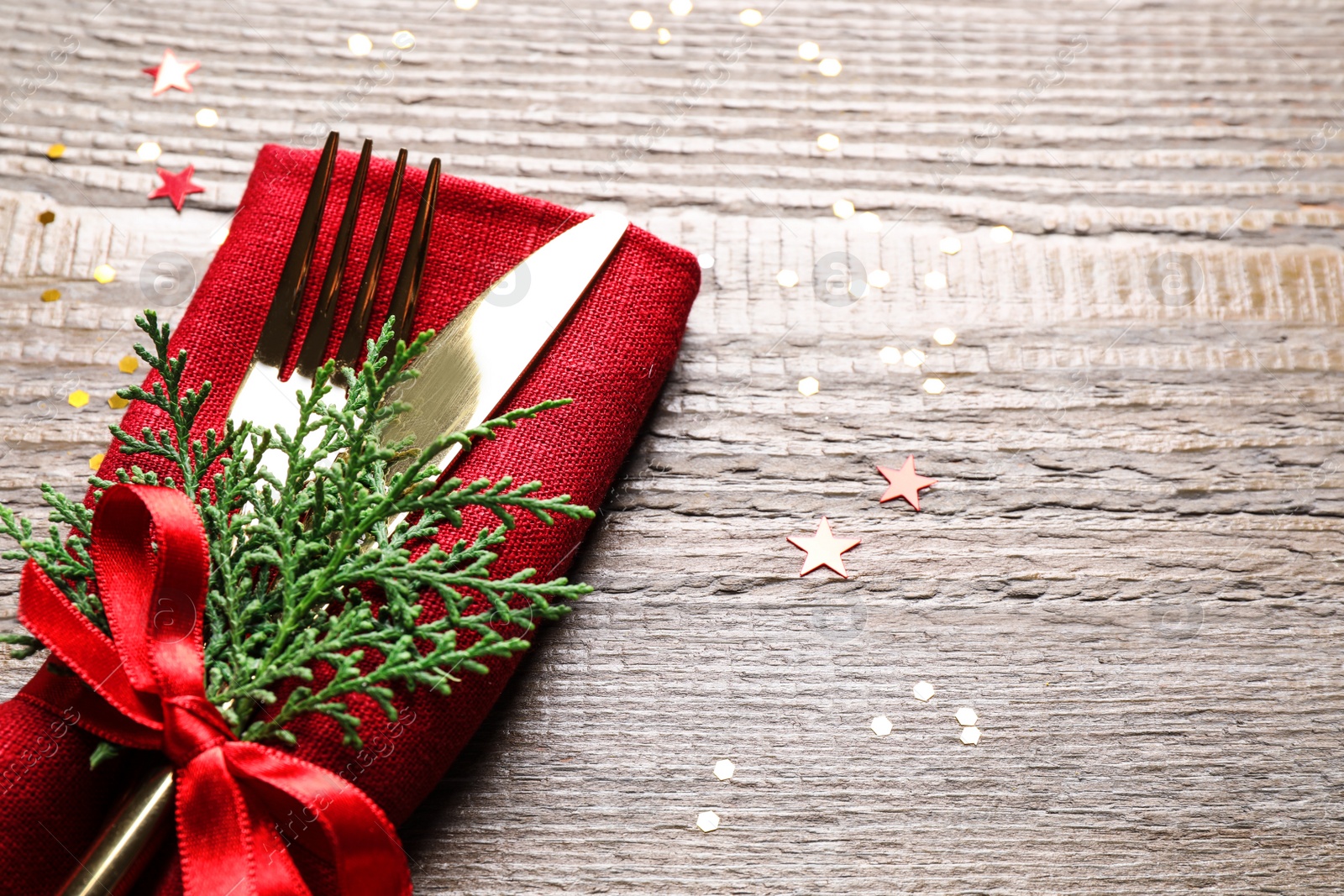 Photo of Cutlery set on wooden table, space for text. Christmas celebration