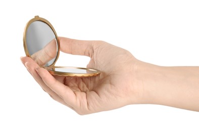 Woman holding gold cosmetic pocket mirror on white background, closeup