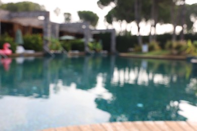 Blurred view of outdoor swimming pool at luxury resort