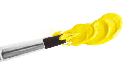 Photo of Yellow paint strokes and brush on white background, top view
