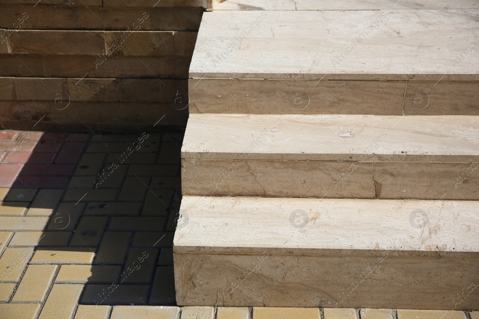 Photo of Beautiful concrete stairs near stone pavement outdoors