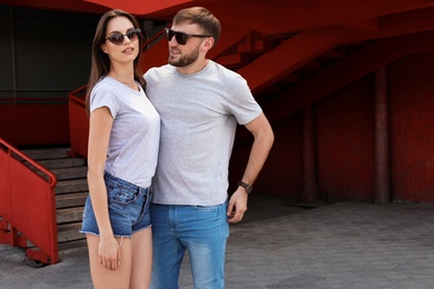 Young couple wearing gray t-shirts on street