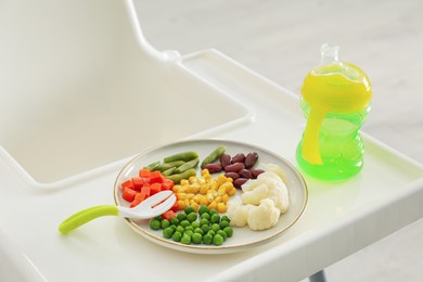 Baby high chair with healthy food and water