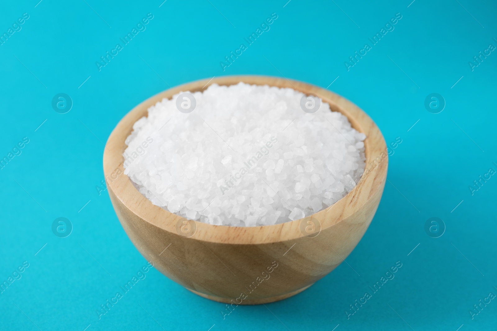 Photo of Organic white salt on light blue background, closeup