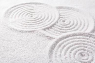 Zen rock garden. Circle patterns on white sand, closeup