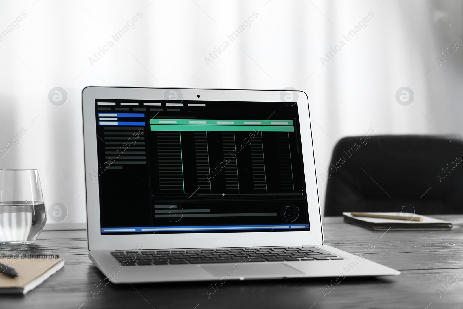 Photo of Modern laptop on wooden table in office