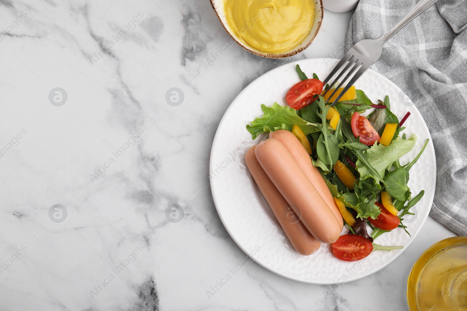 Photo of Delicious boiled sausages with salad served on white marble table, flat lay. Space for text