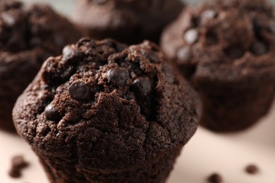 Delicious fresh chocolate muffins on table, closeup