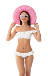 Beautiful young woman in stylish bikini with hat on white background