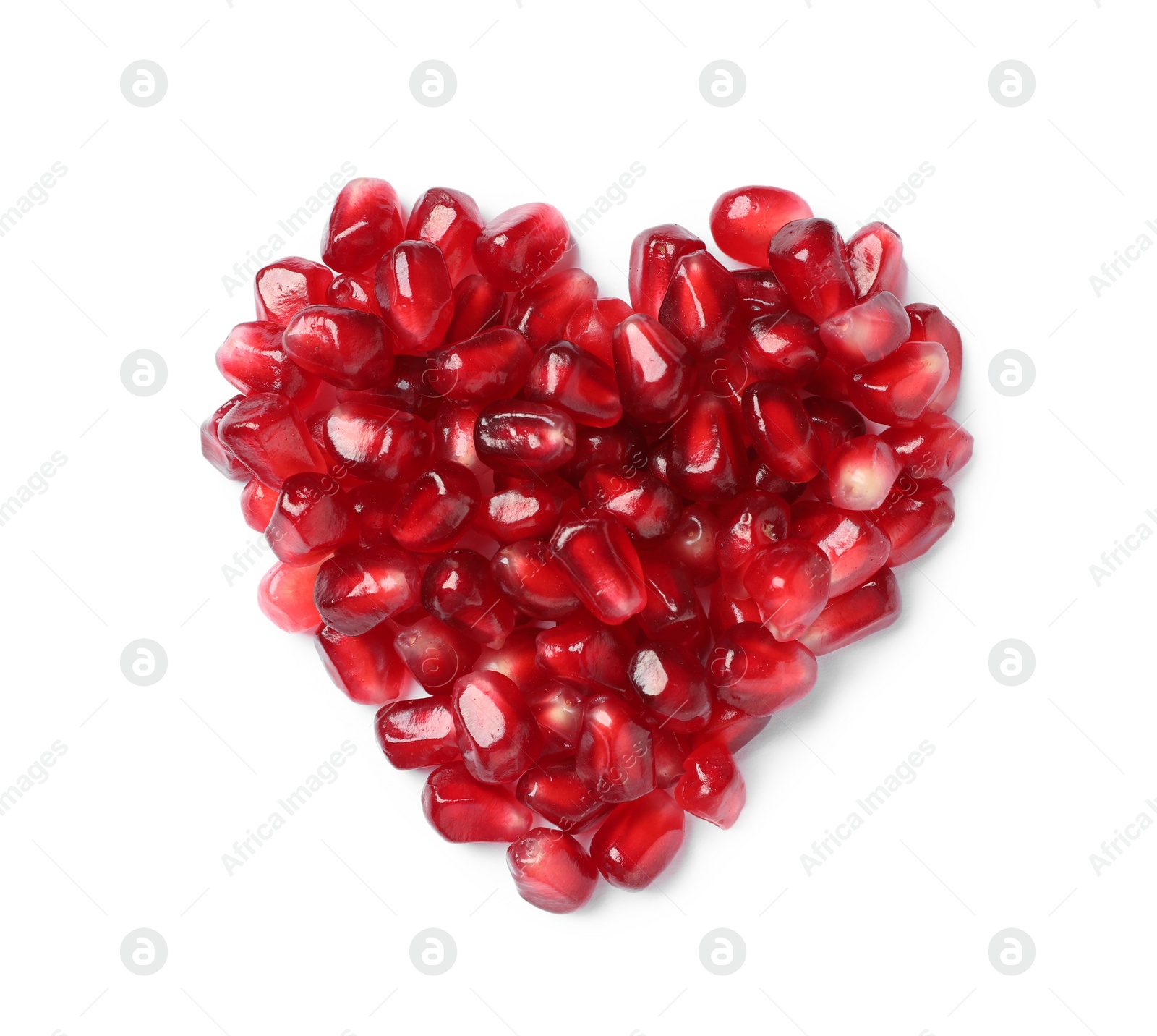 Photo of Heart made of tasty pomegranate seeds on white background, top view