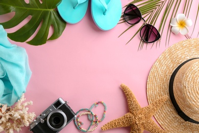 Photo of Flat lay composition with stylish hat, camera and beach objects on color background
