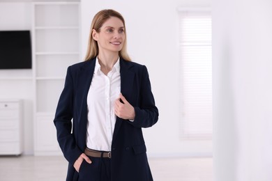 Photo of Happy real estate agent in new apartment. Space for text