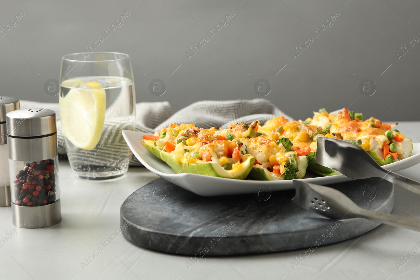 Photo of Composition with baked stuffed zucchinis on light grey table