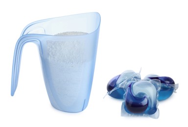 Photo of Laundry capsules and measuring cup of washing powder on white background