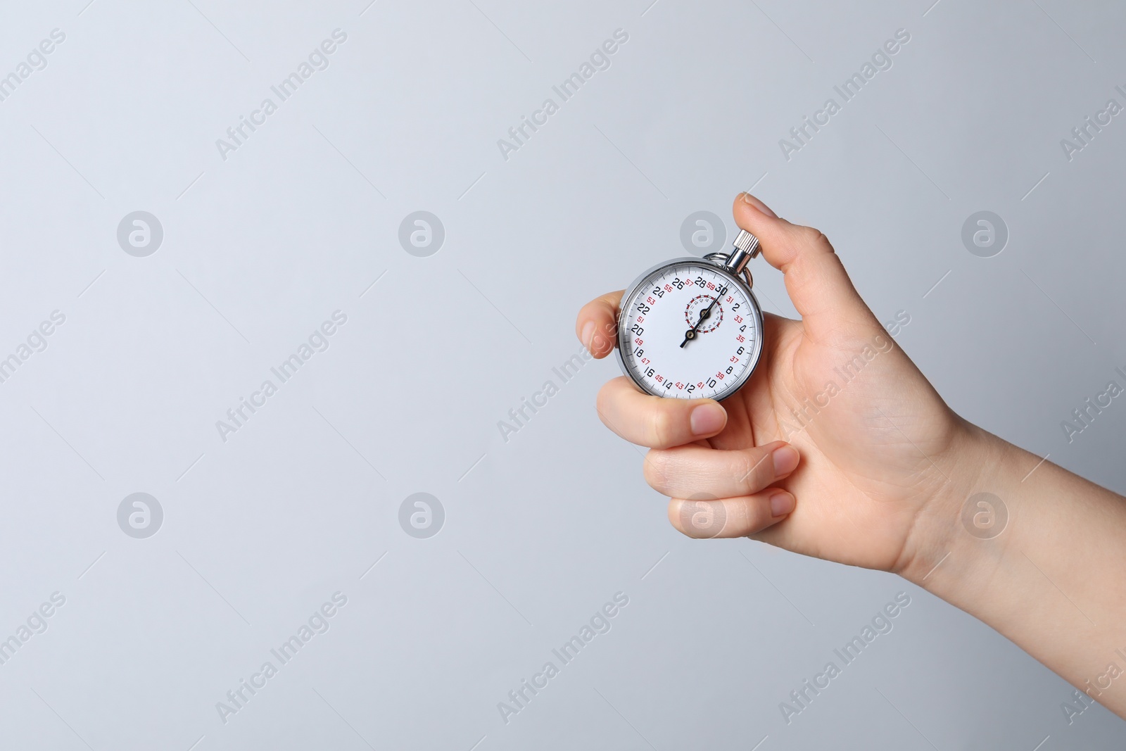 Photo of Woman holding vintage timer on white background, closeup. Space for text